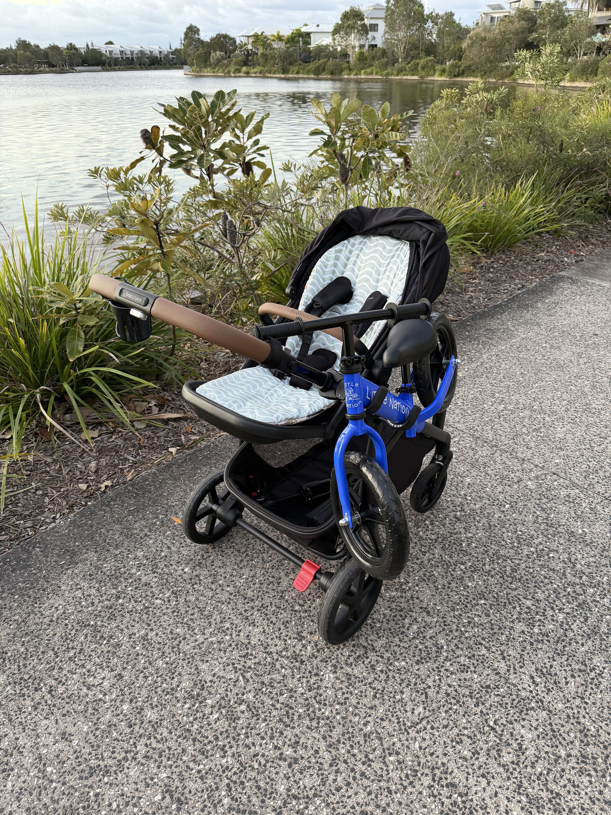 Hook n Go holding a balance bike on a pram