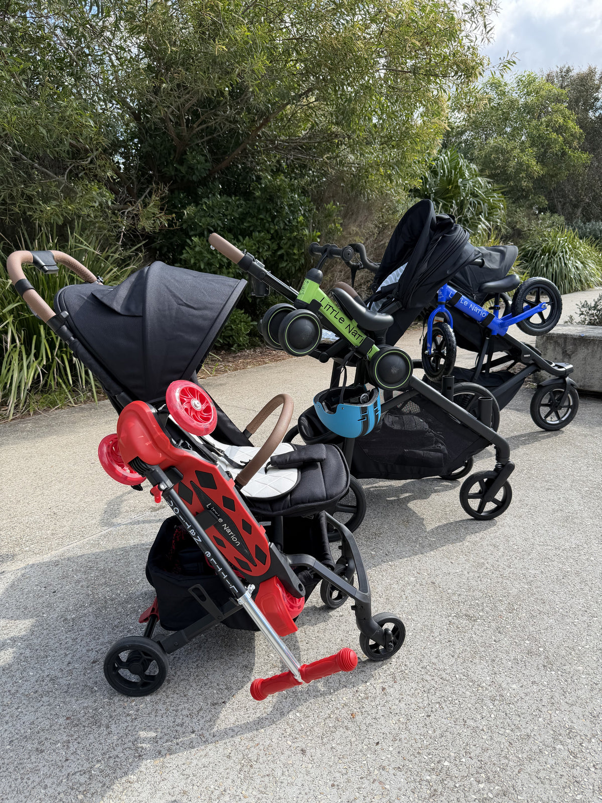 Hook n Go carrying a scooter, balance bike and bike on three different prams